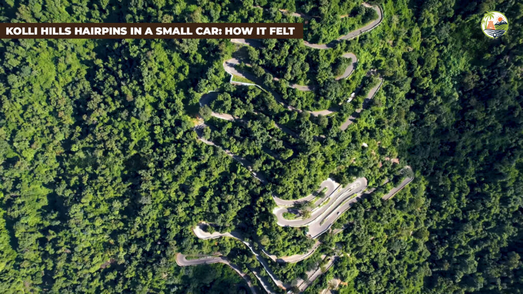Small hatchback navigating a numbered hairpin bend on the Kolli Hills ghat road with the plains visible below.